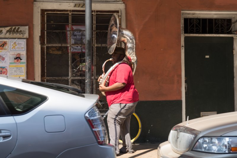 oct2014randommusicianwalkingthroughthefrenchquarterneworleanslouisianadsc05983.jpg